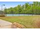 Two public tennis courts with black fencing and lighting at 1026 Towne Mill Xing, Canton, GA 30114
