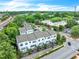 Aerial view of townhomes with lush landscaping, trees, and nearby railroad tracks at 215 Arizona Ne Ave # 6, Atlanta, GA 30307