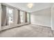 Light-filled bedroom with neutral walls, carpet, and windows dressed with gray curtains at 215 Arizona Ne Ave # 6, Atlanta, GA 30307
