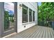 Outdoor deck with gray wood floors and a view of lush greenery at 215 Arizona Ne Ave # 6, Atlanta, GA 30307