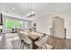 Open-concept dining area with modern lighting, hardwood floors, a fireplace and adjacent living room at 215 Arizona Ne Ave # 6, Atlanta, GA 30307