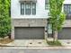 Modern townhome featuring painted brick and stone exterior with a two-car garage at 215 Arizona Ne Ave # 6, Atlanta, GA 30307