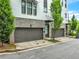 Exterior view featuring garages and landscaping of a brick building at 215 Arizona Ne Ave # 6, Atlanta, GA 30307