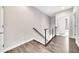 Upstairs hallway with wood floors, modern railing, and a bright and open feel at 215 Arizona Ne Ave # 6, Atlanta, GA 30307