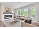 Inviting living room with a fireplace, neutral-toned furniture, and natural light from large windows at 215 Arizona Ne Ave # 6, Atlanta, GA 30307