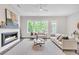 Bright living room with a fireplace, modern decor, and large windows with natural light at 215 Arizona Ne Ave # 6, Atlanta, GA 30307