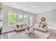 Cozy living room featuring neutral furniture, a ceiling fan, and large windows with scenic views at 215 Arizona Ne Ave # 6, Atlanta, GA 30307