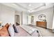 Bright main bedroom features a tray ceiling, neutral colors, carpeted floors, wooden dresser and ensuite bathroom at 215 Arizona Ne Ave # 6, Atlanta, GA 30307