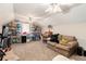Unfinished attic space with carpet flooring, shelving, a couch, and storage containers, presenting opportunities for customization at 65 Macadamia Ct, Covington, GA 30016
