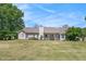 Expansive backyard featuring a well-maintained lawn and a charming covered porch, perfect for outdoor relaxation at 65 Macadamia Ct, Covington, GA 30016