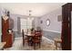 Dining room with hardwood table set, natural lighting and neutral colors at 65 Macadamia Ct, Covington, GA 30016