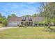 Charming single-story home with a well-manicured lawn, dormer windows, and a welcoming front porch at 65 Macadamia Ct, Covington, GA 30016