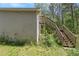 Home exterior featuring a private entrance and steps to an upper level on the side of the property, surrounded by trees at 65 Macadamia Ct, Covington, GA 30016