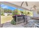 Relaxing front porch area with cozy seating, ceiling fans, and a view of the manicured lawn at 65 Macadamia Ct, Covington, GA 30016