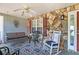 A welcoming front porch includes a swing, chairs, and ceiling fan for a relaxing outdoor space at 65 Macadamia Ct, Covington, GA 30016