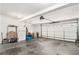 Spacious two-car garage featuring an automatic door opener, ample storage space, and plenty of room for parking and projects at 65 Macadamia Ct, Covington, GA 30016