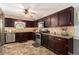 A kitchen offering dark cabinets, stainless steel appliances, stylish backsplash, and granite countertops at 65 Macadamia Ct, Covington, GA 30016