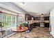 Open kitchen and dining area featuring granite countertops, a bay window, and plenty of natural light at 65 Macadamia Ct, Covington, GA 30016