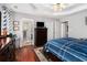 A spacious main bedroom with dark wood furniture and hardwood floors at 65 Macadamia Ct, Covington, GA 30016
