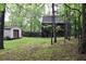 Expansive backyard with lush greenery and a detached garage, offering a private and serene outdoor setting at 6503 Old Macon Hwy, Rex, GA 30273