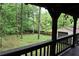 Picturesque backyard view from a porch, featuring mature trees and a detached garage, creating a serene outdoor space at 6503 Old Macon Hwy, Rex, GA 30273