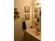 Compact bathroom with deer-themed artwork, a vanity, and a rustic towel rack, providing a unique touch at 6503 Old Macon Hwy, Rex, GA 30273