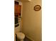 Small bathroom features a toilet, cabinet, and decorative wall art, optimizing space in a cozy setting at 6503 Old Macon Hwy, Rex, GA 30273