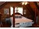Charming bedroom boasts a four-poster bed, complemented by wood-paneled walls and a rustic ceiling fan at 6503 Old Macon Hwy, Rex, GA 30273
