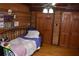 Charming bedroom with wood paneled walls and comfortable furnishings at 6503 Old Macon Hwy, Rex, GA 30273