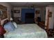 Comfortable bedroom with a four-poster bed, ceiling fan, and entertainment center, creating a cozy retreat at 6503 Old Macon Hwy, Rex, GA 30273
