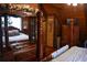 Inviting bedroom featuring a distinctive wooden bed frame and wood-paneled walls, creating a cozy, rustic atmosphere at 6503 Old Macon Hwy, Rex, GA 30273