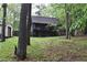 Charming cabin-style home with a wooded setting, featuring a deck and rustic details at 6503 Old Macon Hwy, Rex, GA 30273