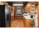 Charming kitchen with wood cabinets, white countertops, and stainless steel refrigerator at 6503 Old Macon Hwy, Rex, GA 30273