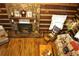 Bright living room with stone fireplace, hardwood floors, wood-paneled walls and ceiling, and comfortable seating at 6503 Old Macon Hwy, Rex, GA 30273