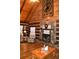 Cozy living room featuring stone fireplace, hardwood floors, and wood-paneled walls and ceiling at 6503 Old Macon Hwy, Rex, GA 30273