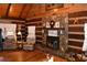 Charming living room with stone fireplace, wood-paneled walls and ceiling, and hardwood floors at 6503 Old Macon Hwy, Rex, GA 30273