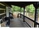 Inviting porch with dark wood railings overlooks a lush backyard, perfect for relaxing and enjoying the scenery at 6503 Old Macon Hwy, Rex, GA 30273