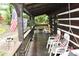 A cozy covered porch with comfortable seating, perfect for relaxing and enjoying the outdoor view at 6503 Old Macon Hwy, Rex, GA 30273