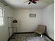 Sunlit bedroom with an accent chair, soft carpet, and a neutral color palette at 1379 Pair Sw Rd, Marietta, GA 30008