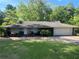 Charming one-story home with a brick facade, manicured lawn, and mature trees offering curb appeal at 1379 Pair Sw Rd, Marietta, GA 30008