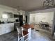 Well-lit kitchen with modern stainless steel appliances, white cabinets, and a dining area for casual meals at 1379 Pair Sw Rd, Marietta, GA 30008