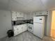 Bright kitchen features ample cabinet space, white appliances, and tile backsplash at 1379 Pair Sw Rd, Marietta, GA 30008