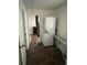 Practical laundry room with a stackable washer/dryer unit and ironing board at 1379 Pair Sw Rd, Marietta, GA 30008