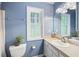 Bright bathroom with vanity, toilet, and large window overlooking backyard at 2317 Danielle Ct, Marietta, GA 30062