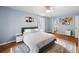 Bright bedroom featuring hardwood floors, a plush bed, and windows for abundant natural light at 2317 Danielle Ct, Marietta, GA 30062