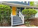 Close-up of the home's entrance featuring a striking yellow door and charming front porch at 2317 Danielle Ct, Marietta, GA 30062