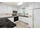 Bright kitchen featuring white cabinets, black countertops, stainless steel appliances, and a sink with a view at 2317 Danielle Ct, Marietta, GA 30062