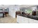 Open concept kitchen featuring a breakfast bar with granite countertops and white cabinets, flowing into living and dining areas at 2317 Danielle Ct, Marietta, GA 30062