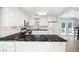 Bright kitchen with white cabinets, black countertops, stainless steel appliances, and access to the deck at 2317 Danielle Ct, Marietta, GA 30062