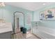 Bright bathroom with a large mirror, soaking tub, and modern finishes at 400 Brooch Way, Stockbridge, GA 30281